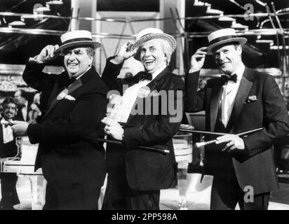 File photo dated 20/12/87 of (left to right) Labour MP for Leeds East, Denis Healey, Barry Humphries, who is dressed as Australian cultural attache Sir Les Patterson, and former James Bond star Roger Moore take part in a Vaudeville routine for LWT's The Dame Edna Christmas Experience. Comedian Barry Humphries, better known as his alter ego Dame Edna Everage, has died at the age of 89, according to a spokesperson for St Vincent’s Hospital in Sydney where he was being treated. Issue date: Saturday April 22, 2023. Stock Photo