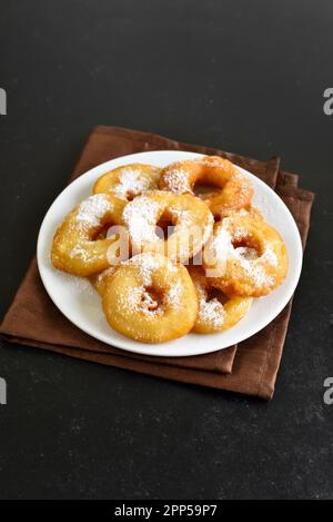 Homemade donuts on white plate on black stone background Stock Photo