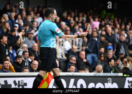 Craven Cottage, Fulham, London, UK. 22nd Apr, 2023. Premier League Football, Fulham versus Leeds United; The assistant referee hold up a missile thrown onto the pitch by the corner flag Credit: Action Plus Sports/Alamy Live News Stock Photo