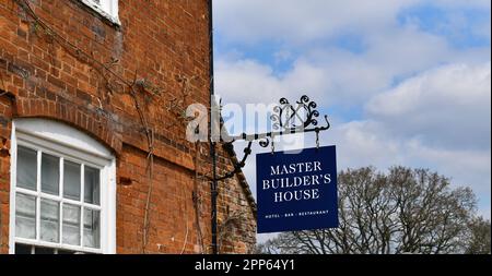 A blue coloured sign with white writing which is situated at Buckler's Hard. The sign is for Master Builder's House, hotel, bar and restaurant Stock Photo