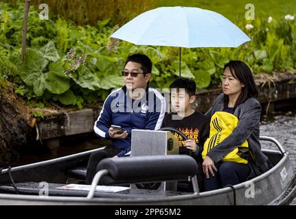 GIETHOORN - Tourists sail in a boat through the rain in Giethoorn during the May holiday. The water region village is a popular destination for tourists and day trippers. ANP SEM VAN DER WAL netherlands out - belgium out Stock Photo