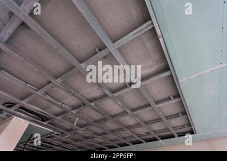 Electrical wiring in a protective corrugation. Installation and wiring of electrical networks in an apartment or house. Close-up Stock Photo