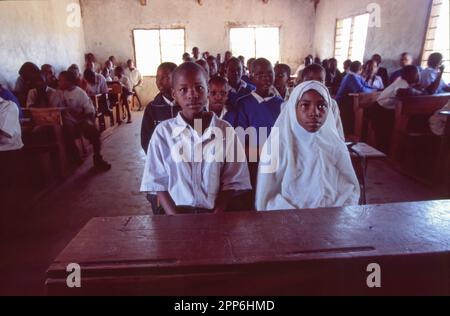 Young students wearing uniform in a simple classroom near Nairobi, Kenya. Africa Stock Photo