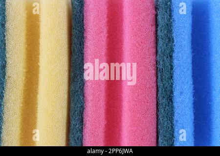 Close up on colorful sponge dish. Top view on pink, yellow and blue color sponge dish. Full off screen. Stock Photo