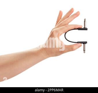 electric guitar pedal patch cable in hand path isolated Stock Photo