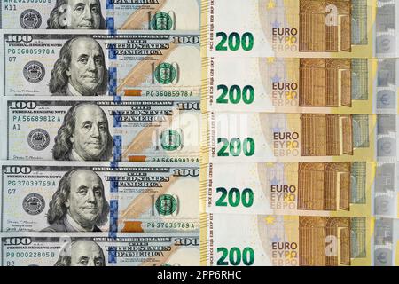 American money banknotes bills with European cash money banknotes, USA dollars, 100 dollars and 200 Euros papers exchange rate Stock Photo