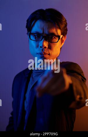 Angry confident man in glasses pointing at camera Stock Photo