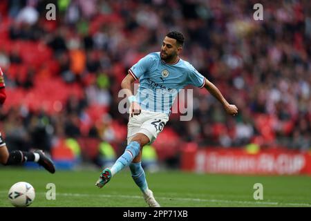 London, UK. 22nd Apr, 2023. Riyad Mahrez of Manchester City shoots and scores his teams 2nd goal . The Emirates FA Cup, semi final, Manchester City v Sheffield Utd at Wembley Stadium in London on Saturday 22nd April 2023. Editorial use only. pic by Andrew Orchard/Andrew Orchard sports photography/Alamy Live News Credit: Andrew Orchard sports photography/Alamy Live News Stock Photo