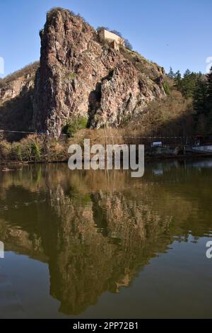 Bad Kreuznach, Germany - February 25, 2021: Rock cliff and reflection in the Nahe River on a sunny winter day in Bad Kreuznach, Germany. Stock Photo