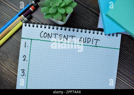 Concept of Content Audit write on book isolated on Wooden Table. Stock Photo