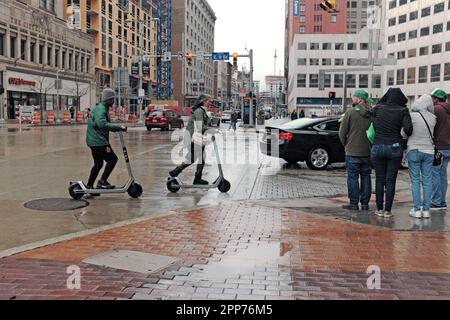 People on the streets of downtown Cleveland, Ohio at the intersection of East 9th and Euclid Avenue on a rainy March day in 2023. Stock Photo