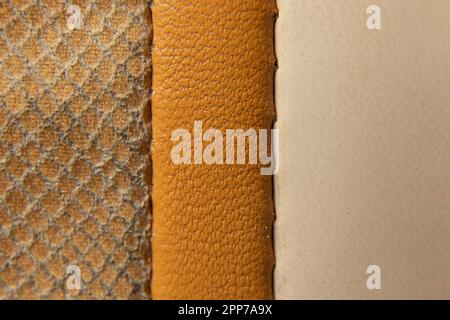 three stitched strips of beige fabric as a background of different shades closeup Stock Photo