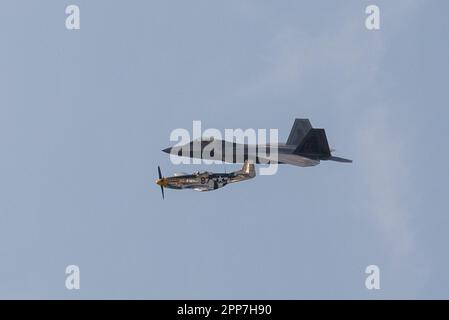 Toronto, ON, Canada – September 2, 2017:  U.S. Air Force F-22 Raptor and P-51 Mustang fly together during the 2017 Canadian International Air Show in Stock Photo