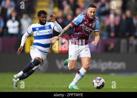 Burnley, UK. 22nd Apr, 2023. Kenneth Paal of Queens Park Rangers and Josh Brownhill of Burnley during the Sky Bet Championship match at Turf Moor, Burnley. Picture credit should read: Gary Oakley/Sportimage Credit: Sportimage Ltd/Alamy Live News Stock Photo