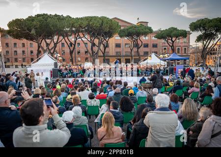 Spectators attend the concert of the Italian army band conducted by Sergeant Major Pasquale Casertano. Figures from all over the world united by their passion for the world of ancient Rome have set up an ancient village at the Circus Maximus to celebrate the 2776th anniversary of the foundation of Rome. The event organized by the Gruppo Storico Romano, a non-profit cultural association born in 1994 from a passion for ancient Rome, this year sees the participation of 2500 re-enactors belonging to 80 associations from 16 nations. The largest number of re-enactors come from Spain. The day ends wi Stock Photo