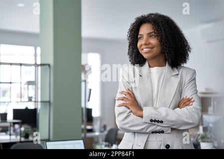 Happy portrait of African American woman stands confident and looking aside Stock Photo
