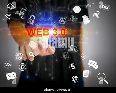 A man's hand activates powerful Web 3.0 technology for many digital activities such as virtual reality, chatbots, cryptocurrency, cloud computing, and Stock Photo