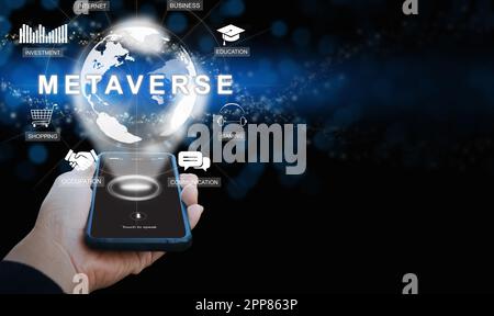 Metaverse on a smartphone. A hand holding a phone activates Metaverse on the virtual screen. The use of augmented reality technology. The Internet as Stock Photo