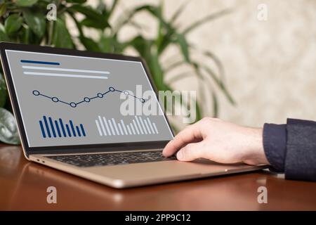 Businessman analyzing investment charts with laptop. Business and finance Stock Photo