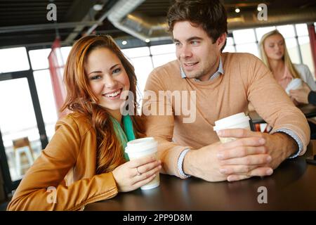 Enjoying their first date. A happy young couple on a date in a coffee shop. Stock Photo