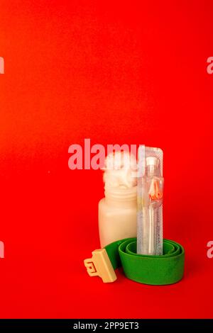 Cotton fiber texture in the white bottle with iv cannula . isolated on red background Stock Photo