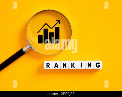Increase ranking. Search engine optimization SEO rankings concept. The word ranking on white cubes with a magnifier on a graph icon. Stock Photo