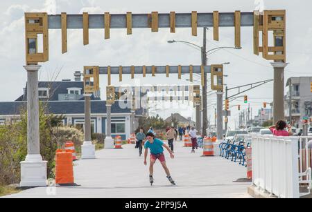 Cape May, United States. 22nd Apr, 2023. A roller skater passes through the under construction Cape May Promenade Arches Saturday, April 22, 2023 at along the promenade in Cape May, New Jersey. The archways are seen as a return of a picturesque detail of old Cape May, whose original arches were destroyer by a hurricane in 1944. ( Credit: William Thomas Cain/Alamy Live News Stock Photo