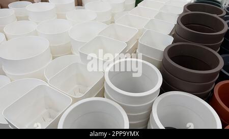Close-up of empty flower pots in a store or greenhouse. Colorful pots for plants. Gardening and landscape design concept Stock Photo