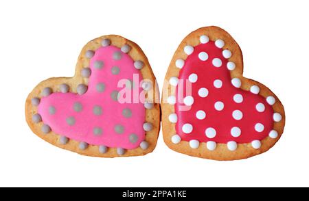 Pair of lovely dotted patterned royal icing heart shaped cookies on white background Stock Photo