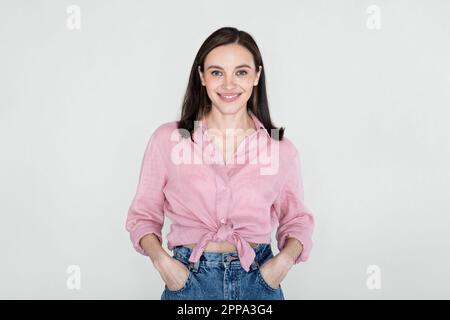 Happy beautiful young woman in casual posing on studio background Stock Photo
