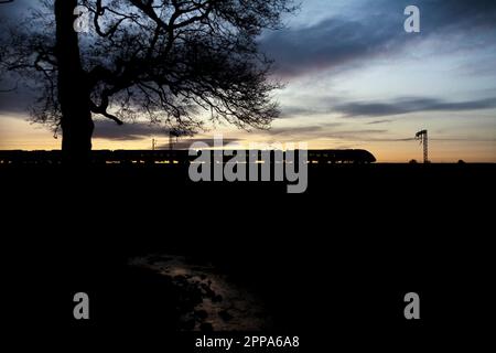 First Transpennine Express CAF class 397 Nova 2 train on the west coast mainline at sunset Stock Photo