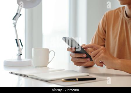 Businessman using application on smartphone when planning day Stock Photo