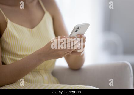 Mobile phone in hands of young woman close up Stock Photo