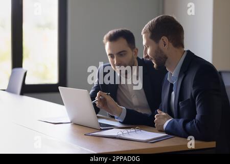 Two positive business colleagues men testing new professional application Stock Photo
