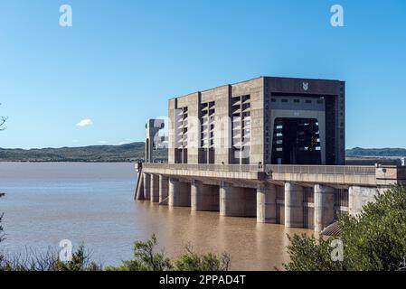 The Gariep Dam overflowing. A radial gate valve hoist structure is visible. The dam is the largest in South Africa. Stock Photo