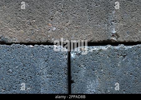 Gray building cinder blocks made of cement stacked close-up background. Lot of large concrete bricks stacking texture Stock Photo