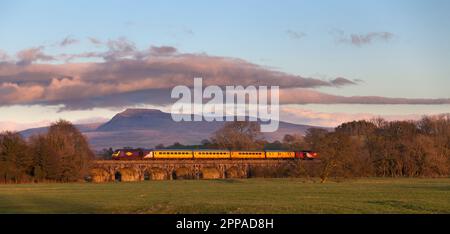 The Network Rail plain line pattern recognition train, monitoring the track passing Melling viaduct with Ingleborough behind, Yorkshire, UK Stock Photo