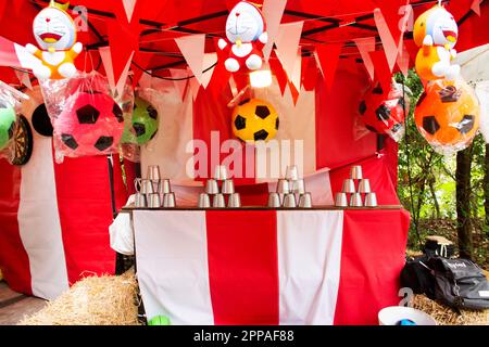 Antique game throwing and shooting balls to cans knockdown of local carnival funfair festival for thai people and foreign travelers travel visit and p Stock Photo