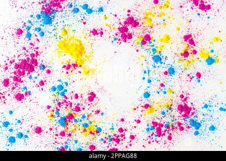 Yellow pink blue holi color powder splatter white background Stock Photo