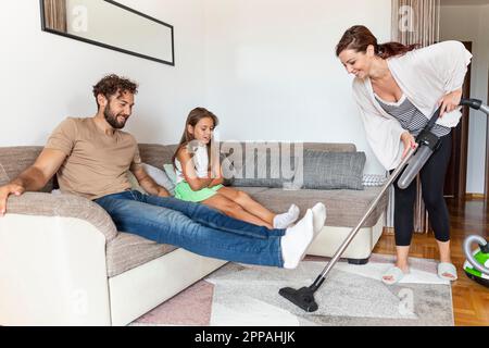 Woman vacuuming carpet Stock Photo