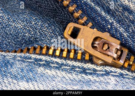 Open zipper of a worn out blue jeans Stock Photo