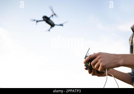 Close up hands of man controls a drone. High quality photo Stock Photo