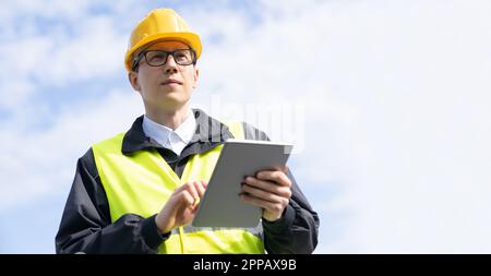 Engineer with digital tablet on a background of blue sky. High quality photo Stock Photo