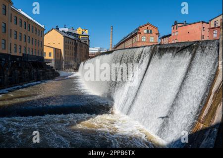 Waterfall in the historic industrial landscape during spring in Norrköping, Sweden Stock Photo