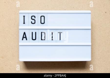 Lightbox with word ISO audit on wood background Stock Photo