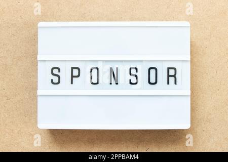 Lightbox with word sponsor on wood background Stock Photo