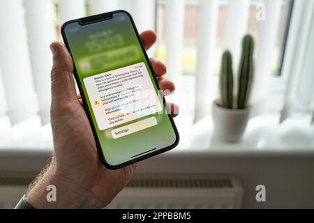 Government emergency text message seen displayed on a persons mobile phone. This alert is a government UK wide test for future emergency situations. Stock Photo