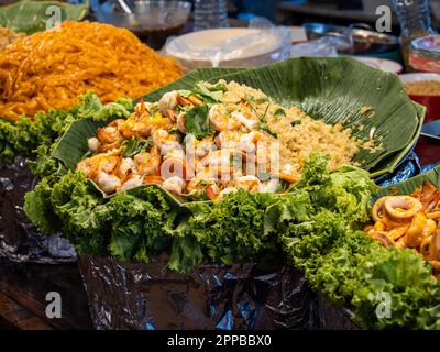 The Thai street food is delicious and always served fresh. Here are delicious seafood dishes, prawns, shrimps, octupus, squids and rice at a street fo Stock Photo