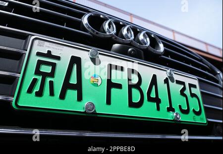 Peking, China. 15th Apr, 2023. An Audi with a green license plate stands in front of Volkswagen's V-Lab research and development center in Beijing's Chaoyang district. The green plate shows that it is a car with an electric drive. With a focus on vehicle safety, connectivity and e-mobility, V-Lab has been developing products for all VW brands since 2013. Credit: Soeren Stache/dpa/Alamy Live News Stock Photo