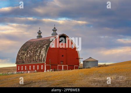 Red barn on a farm in the Palouse hills. Stock Photo